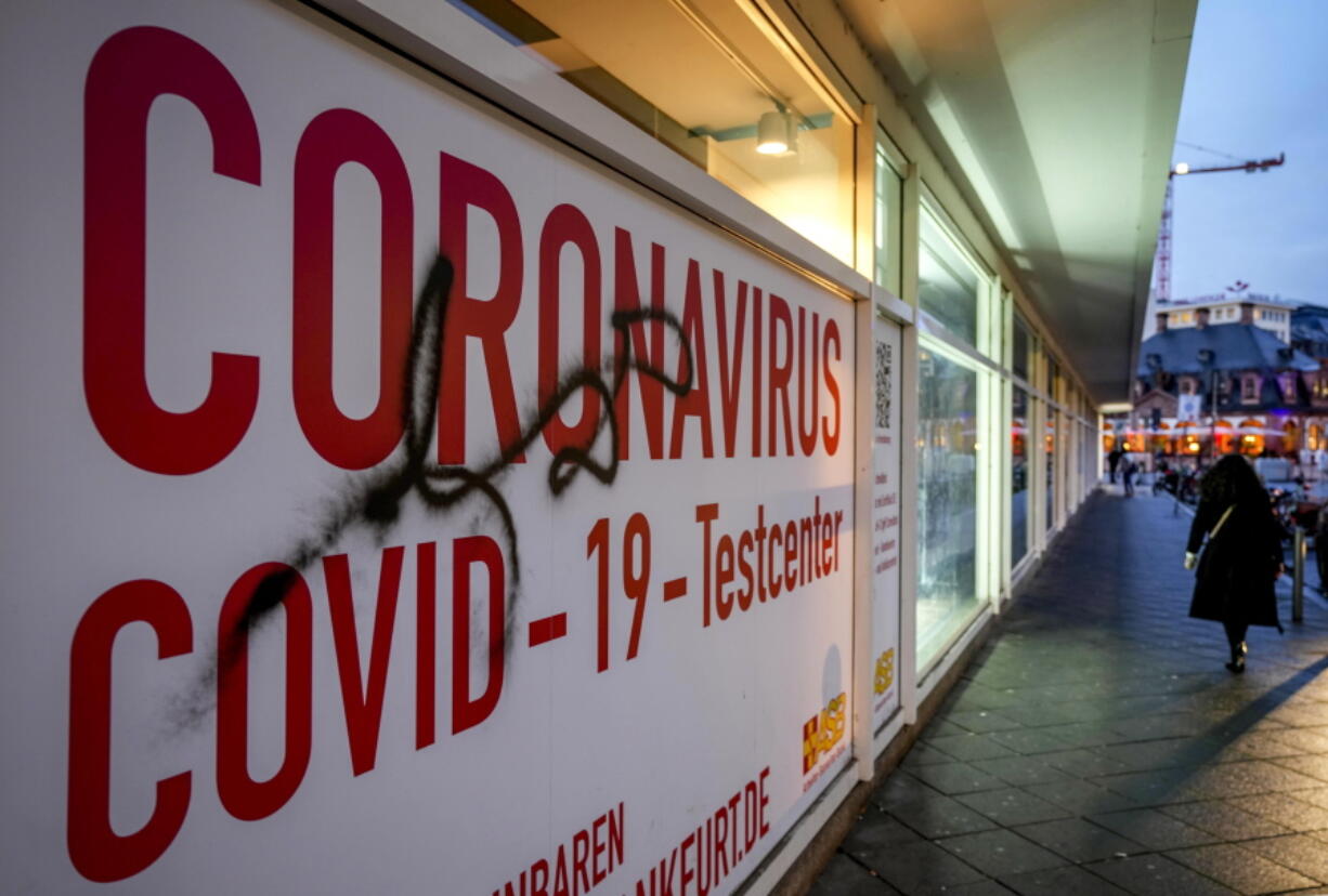 A woman walks past an abandoned coronavirus test center in Frankfurt, Tuesday, Nov. 2, 2021. Numbers of coronavirus infections are rising again in Germany.