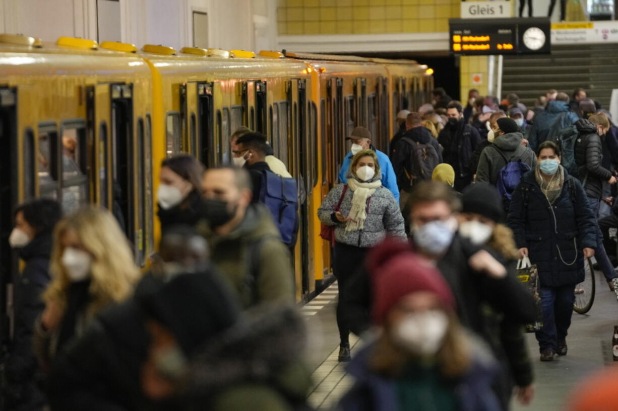 People wear face mask to protect against the coronavirus at the public transport station Friedrichstrasse in Berlin, Germany, Tuesday, Nov. 30, 2021. According to local authorities wearing face masks mandatory in public transport and passengers need to be vaccinated, recovered or tested negative of the coronavirus.