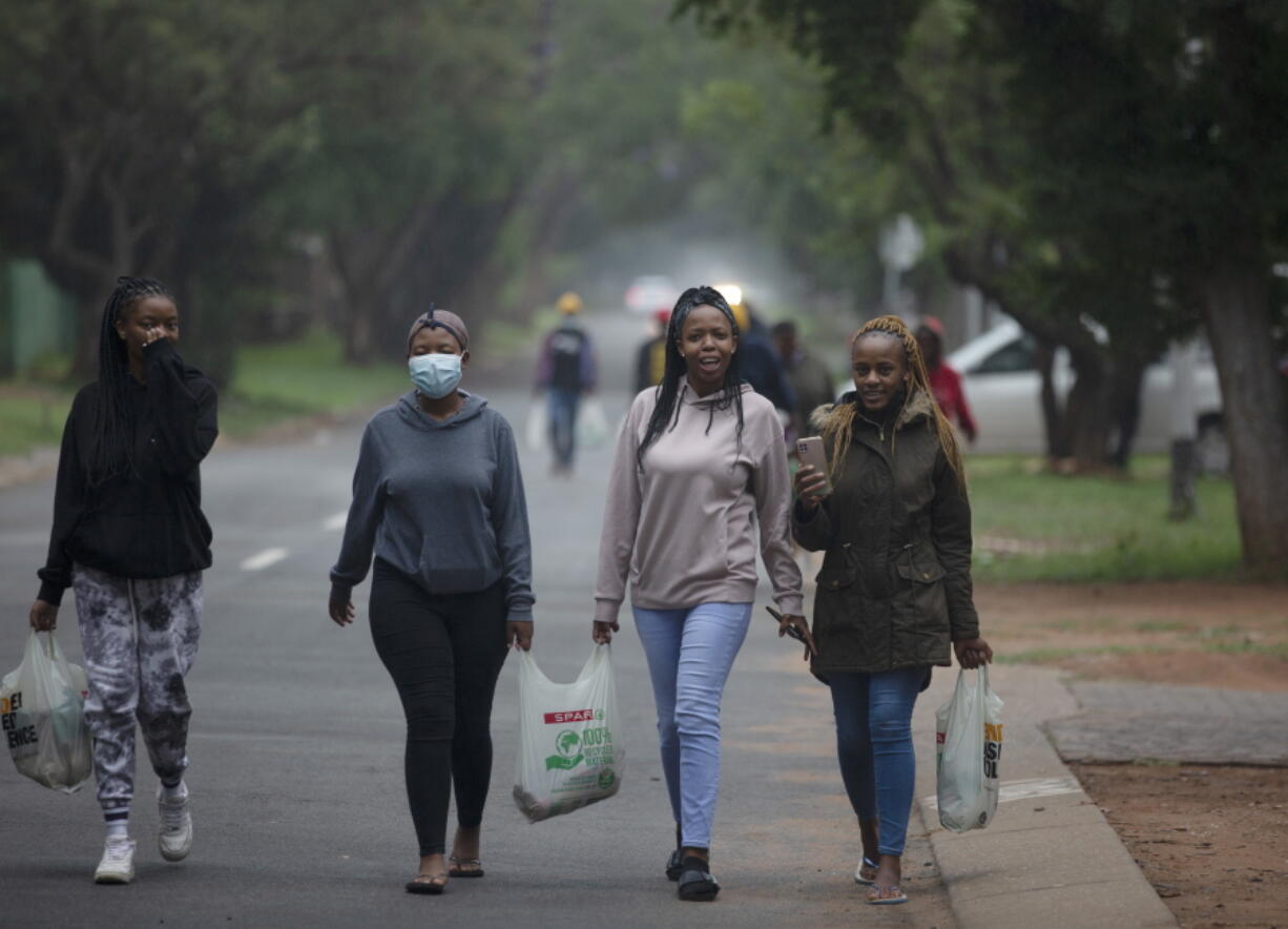 Students from the Tshwane University of Technology make their way back to their residence in Pretoria, South Africa, Saturday, Nov. 27, 2021. As the world grapples with the emergence of the new variant of COVID-19, scientists in South Africa -- where omicron was first identified -- are scrambling to combat its spread across the country.