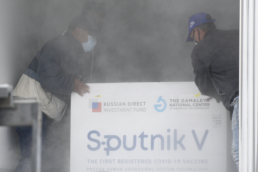 FILE - Workers place a box containing doses of the Russian COVID-19 vaccine Sputnik V into a refrigerated container after unloading it from a plane, at the Simon Bolivar International Airport in Maiquetia, Venezuela, Feb. 13, 2021. On Monday, the U.S. will implement a new air travel policy to allow in foreign citizens who have completed a course of a vaccine approved by the Food and Drug Administration or the World Health Organization. That leaves people in Mexico, Hungary, Russia and elsewhere who received the non-approved Russian Sputnik V vaccine or the China-produced CanSino vaccine ineligible to board U.S.-bound flights.