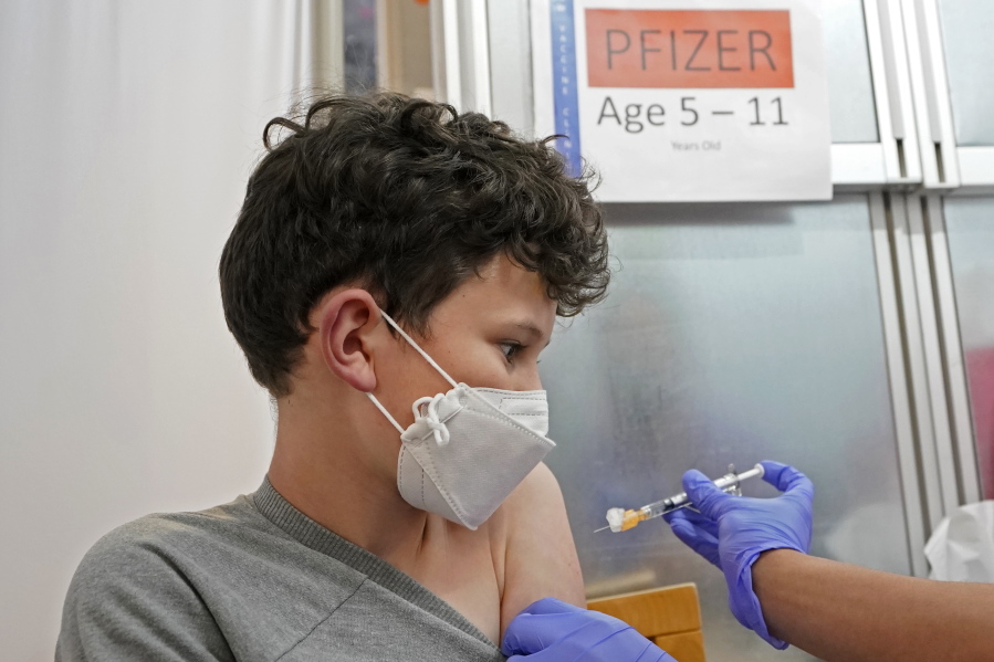 Leo Hahn, 11, gets the first shot of the Pfizer COVID-19 vaccine, Tuesday, Nov. 9, 2021, at the University of Washington Medical Center in Seattle. Last week, U.S. health officials gave the final signoff to Pfizer's kid-size COVID-19 shot, a milestone that opened a major expansion of the nation's vaccination campaign to children as young as 5. (AP Photo/Ted S.