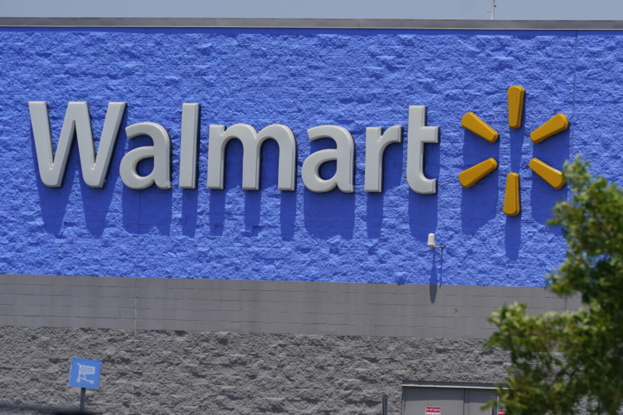 A sign at a Walmart store is pictured Thursday, June 24, 2021, in Oklahoma City.  Walmart Inc.on Tuesday, Nov. 16, reported fiscal third-quarter net income of $3.11 billion. On a per-share basis, the Bentonville, Arkansas-based company said it had profit of $1.11.