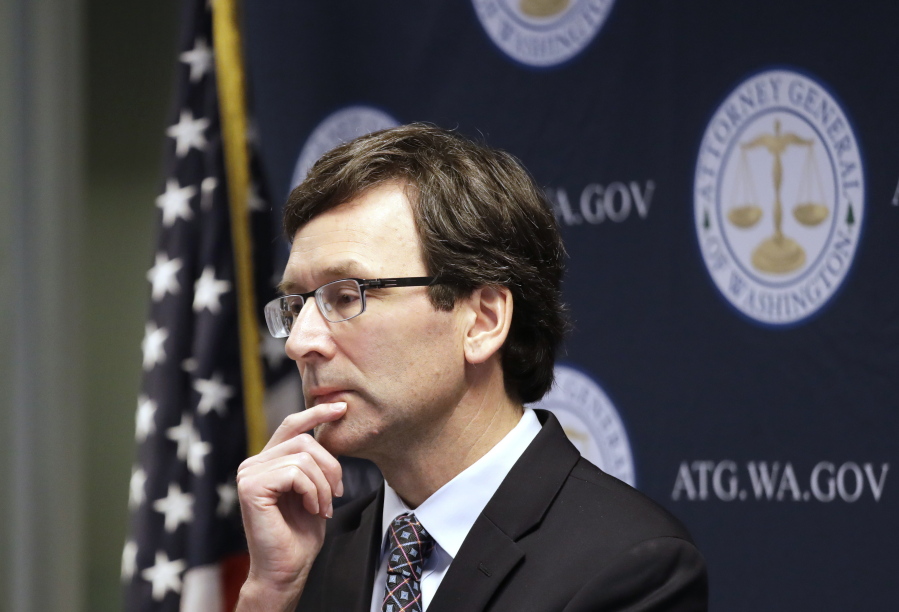 FILE - Washington state Attorney General Bob Ferguson looks on during a news conference in Seattle on Dec. 17, 2019. Ferguson rejected a half-billion-dollar settlement offer, and now he's taking the state's case against the nation's three biggest drug distributors to trial Monday, Nov. 15, 2021. He says they must be held accountable for their role in the opioid crisis.