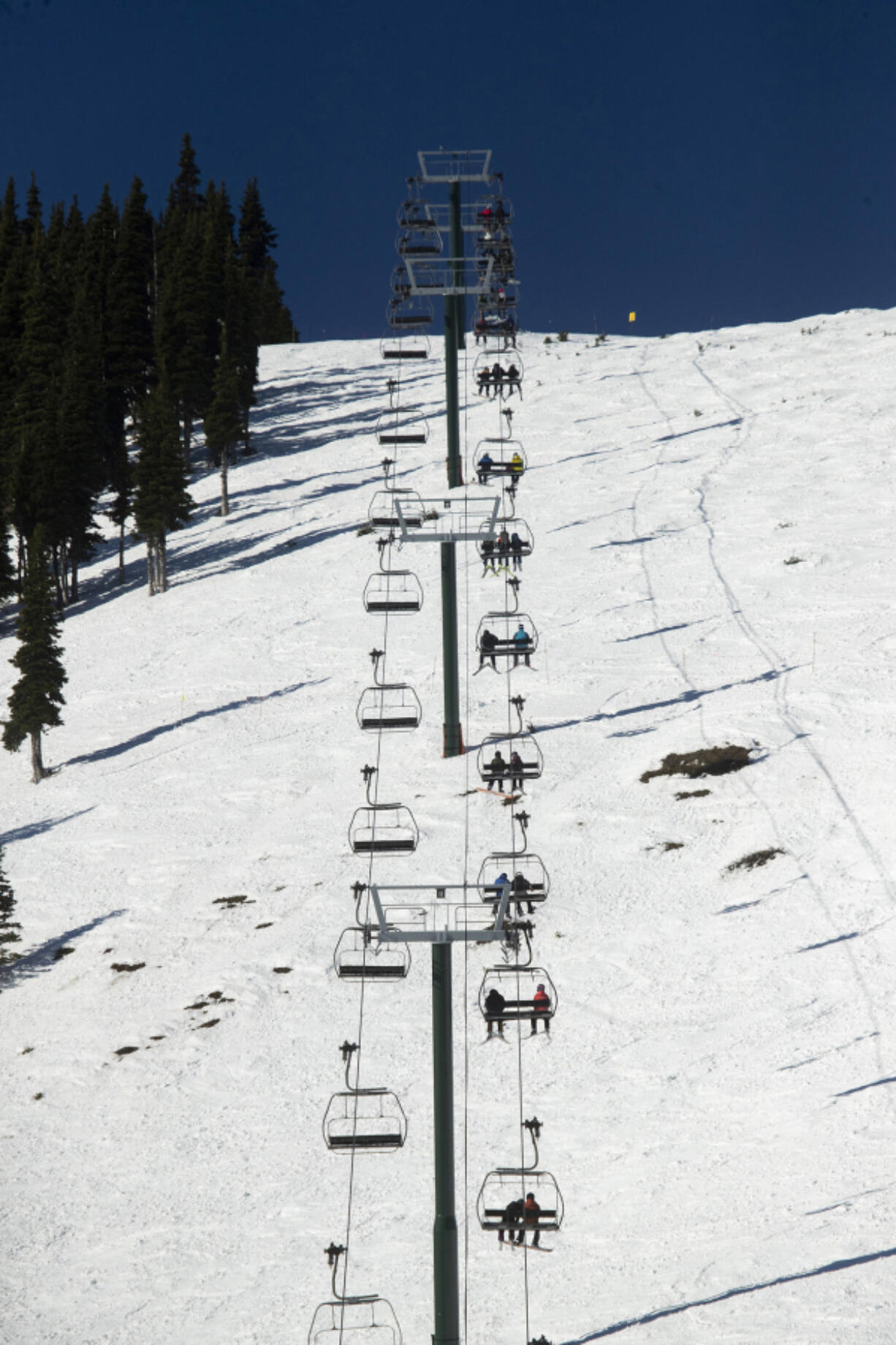 Skiers ride the Rainier Express at Crystal Mountain ski resort Dec. 2, 2020. Washington's biggest ski area is the closest thing to a true resort in the state.