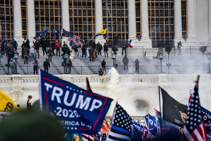 Supporters of US President Donald Trump clash with the US Capitol police during a riot at the US Capitol on Jan. 6, 2021, in Washington, DC. Donald Trump's supporters stormed a session of Congress held January 6 to certify Joe Biden's election win, triggering unprecedented chaos and violence at the heart of American democracy and accusations the president was attempting a coup.