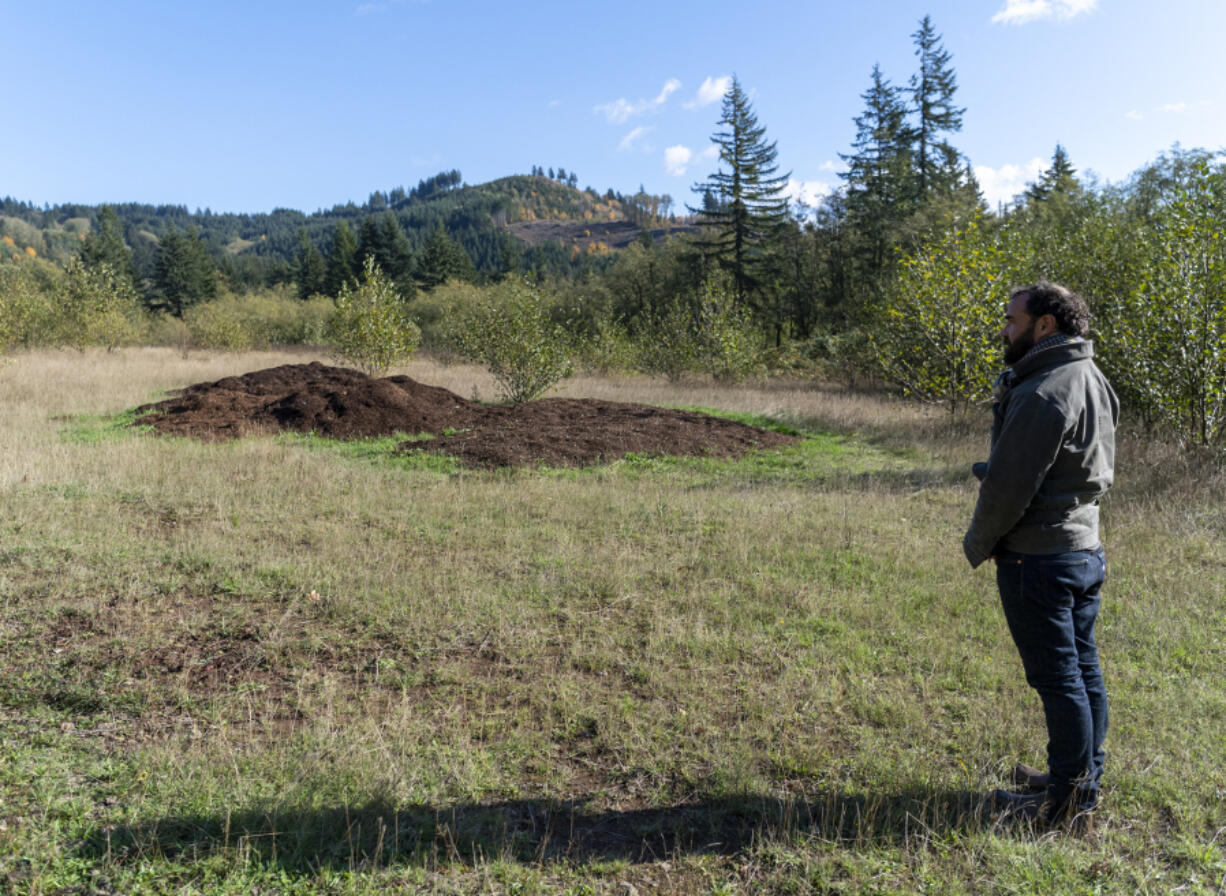 Remember Land Executive Director Elliot Rasenick stands in front of a mound of NOR, or natural organic reduction, from Kent-based human composting funeral home Recompose.