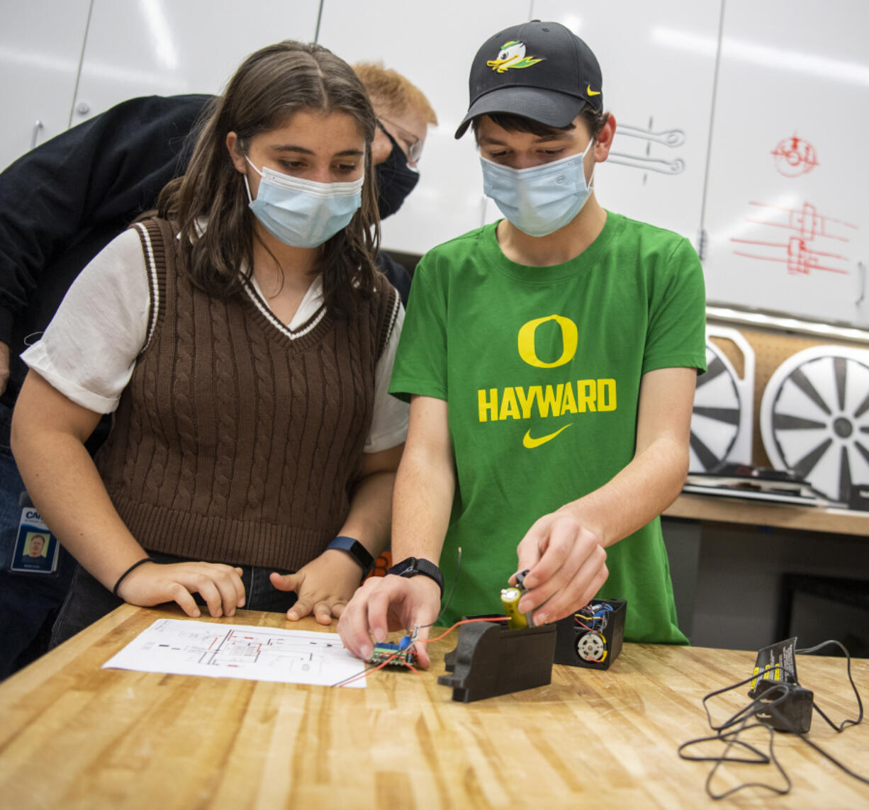 Discovery High School sophomore Jack Harding, right, and freshman Silvia Pujol talk about the wiring inside the motor housing of the Power Pivot on Dec. 1 at Discovery High School. Each housing unit is designed to fit a number of wires and motors into a tight space, and takes about 12 hours to create using a 3D printer.