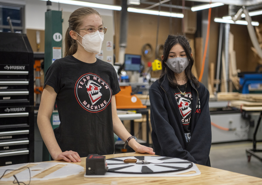 Odyssey Middle School eighth-graders Taryn Cavill, left, and Haley Crowell talk about the Power Pivot on Dec. 1. The team's inclusion of middle-schoolers allows students to get a head start in project-based learning programs like robotics before they start high school.