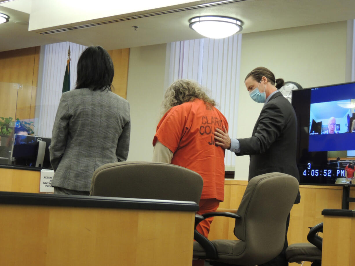 Defense attorney Tony Schwartz, right, comforts Asenka Miller Wilber, center, as she reads her statement to the judge before being sentenced to 20 years in prison. She pleaded guilty last month to second-degree domestic violence murder in the 2018 slaying of her 75-year-old mother.