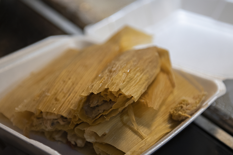 Fresh tamales are sold to a customer at Dulce Tentacion on Monday morning. The shop has the necessary permits to make and sell tamales, but other tamale makers say high permitting costs for their seasonal treat has pushed them into the shadow economy.