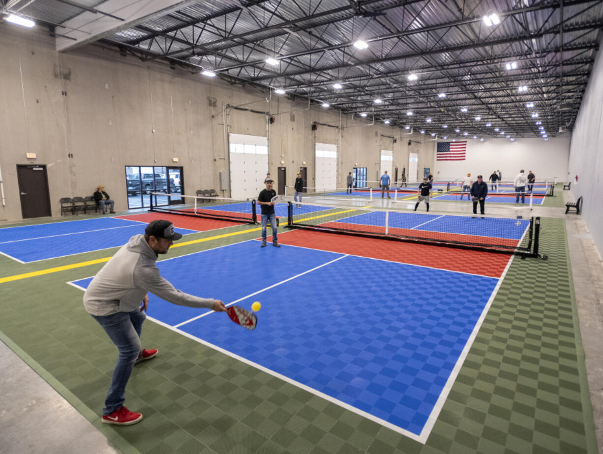 Conner Weber, bottom left, returns a volley at Padelhorn in Vancouver. Padelhorn is the first indoor pickleball-only business in Vancouver or Portland.
