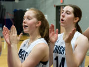 Bridget and Laurel Quinn cheer after the National Anthem is completed before a non-league basketball game on Thursday, Dec. 9, 2021, at King's Way Christian School.