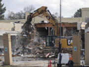 An excavator loads debris into trucks Wednesday at Vancouver's former Tower Mall. The building is being demolished as part of The Heights District Plan, an initiative by the city of Vancouver to transform the site into a mixed commercial and residential space.