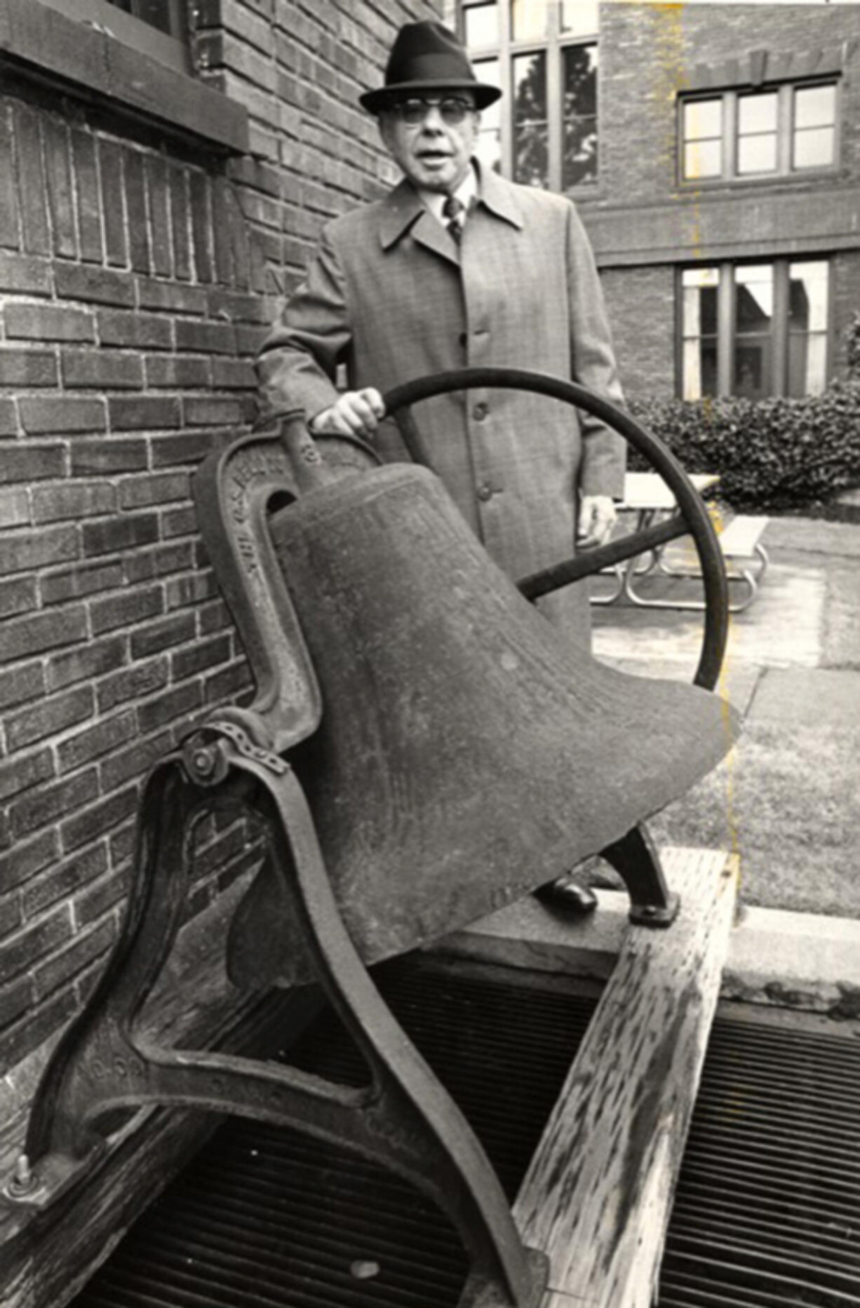 Although blind, Emil Fries (pronounced "freeze") founded The Piano Hospital in 1949 and directed it until 1997. He stands next to the dinner bell that once rang students to meals. Students from around the world sought out his tuning technique that harmonized hands and ears to tune pianos.
