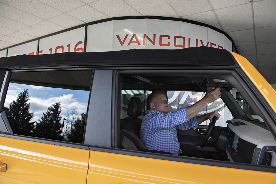 Sales manager Tony Pryor looks over the interior of a 2021 Ford Bronco while posing for a media photo at Vancouver Ford on Tuesday morning.