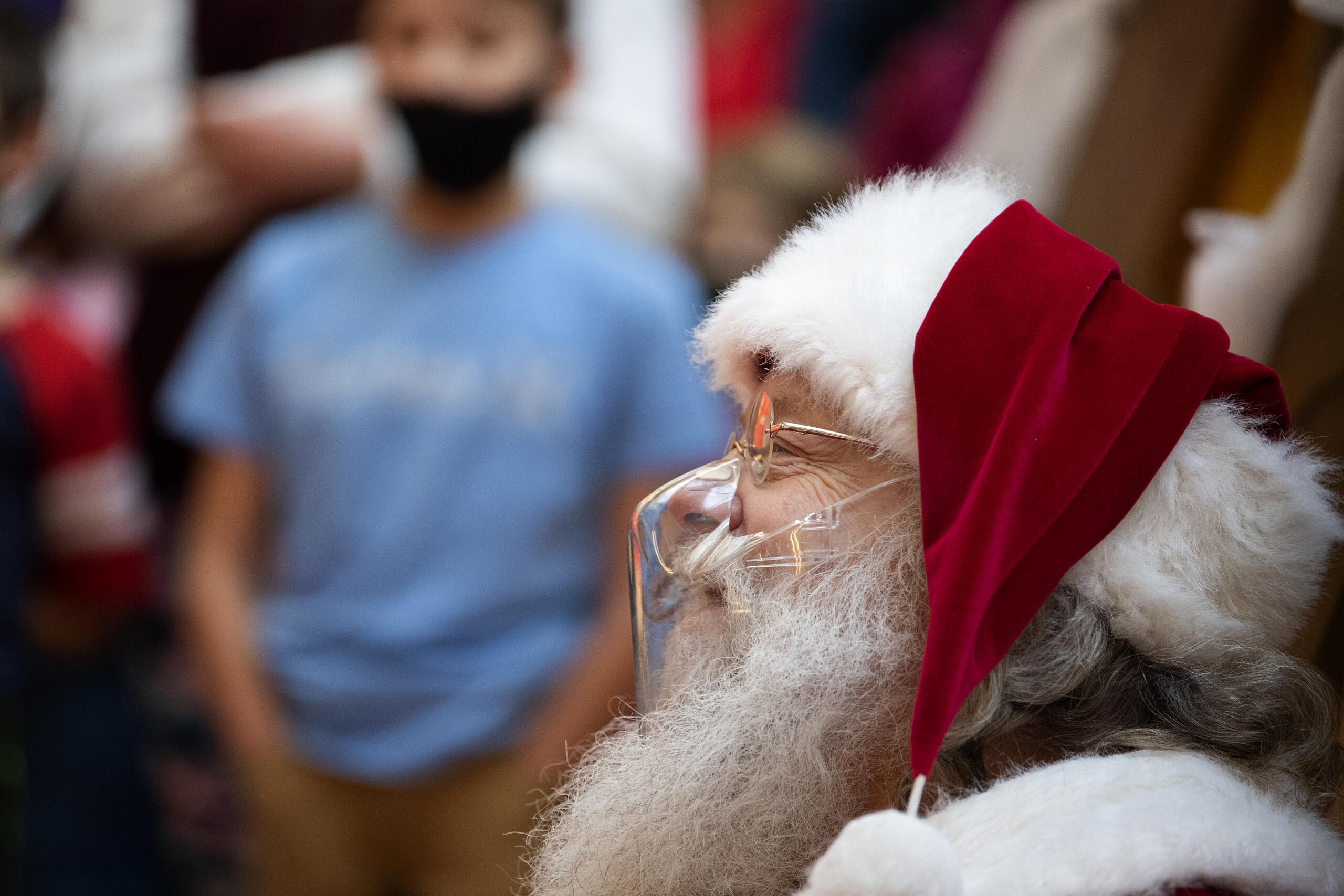 Santa Claus, as portrayed by Tom High, wears a clear, acrylic mask as a COVID-19 precaution while greeting kids of all ages at Vancouver Mall on Friday afternoon, Dec. 24, 2021.