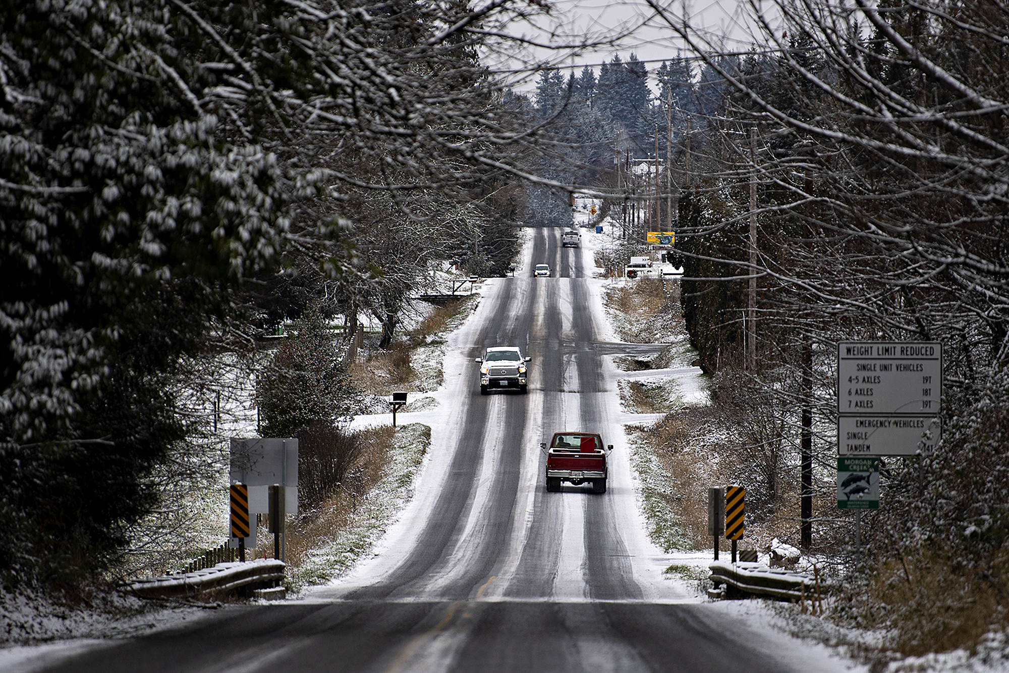 Drivers in Hockinson navigate through a snowy scene after a light blanket of snow dusted the area Monday morning, Dec. 27, 2021.