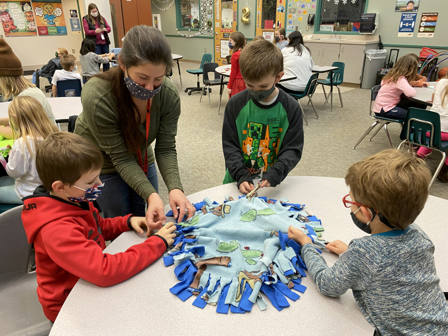 Cape Horn-Skye first-grade students participated in their annual holiday inspired lesson that demonstrates the fun of giving by creating tie blankets and toys for dogs and cats at the local humane society shelter.
