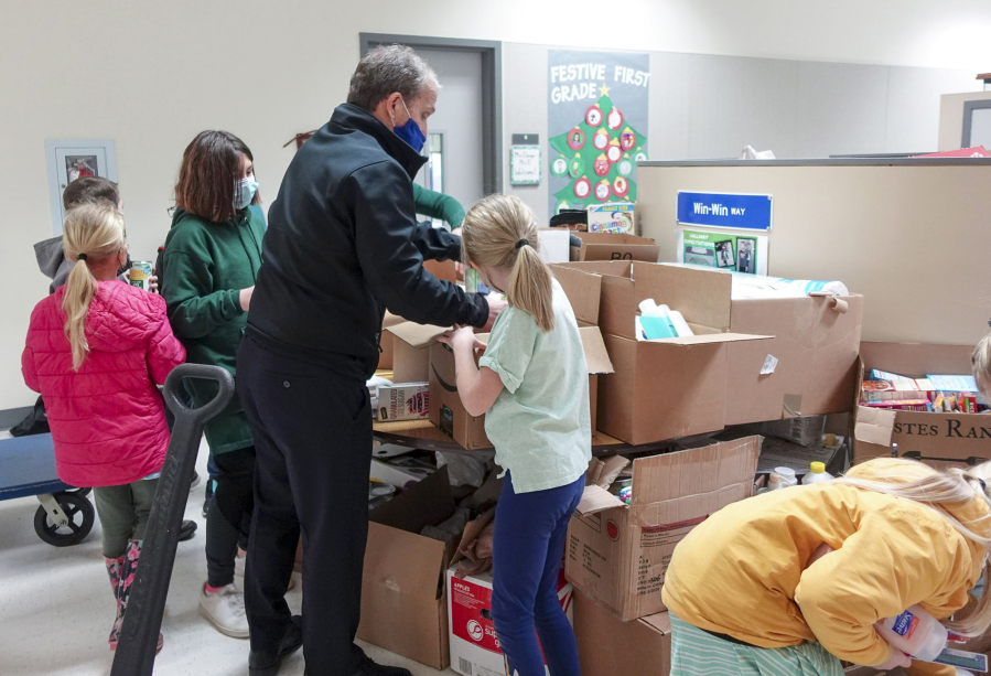 BATTLE GROUND: Student-led donation drives filled trucks with thousands of pounds of food and other items for local food banks, giving trees provided gifts for families in need, and drive-through holiday celebrations saw long lines at several schools.