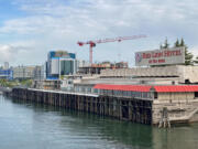 New development along the Vancouver waterfront rises behind the former Red Lion Hotel at the Quay earlier this year. The hotel is in the early stages of demolition.
