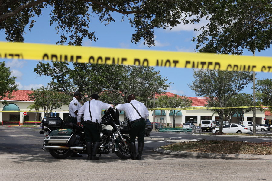 Palm Beach County Sheriff???s officers stand outside of a Publix supermarket where a woman,  child and a man were found shot to death on June 10, 2021, in Royal Palm Beach, Florida.