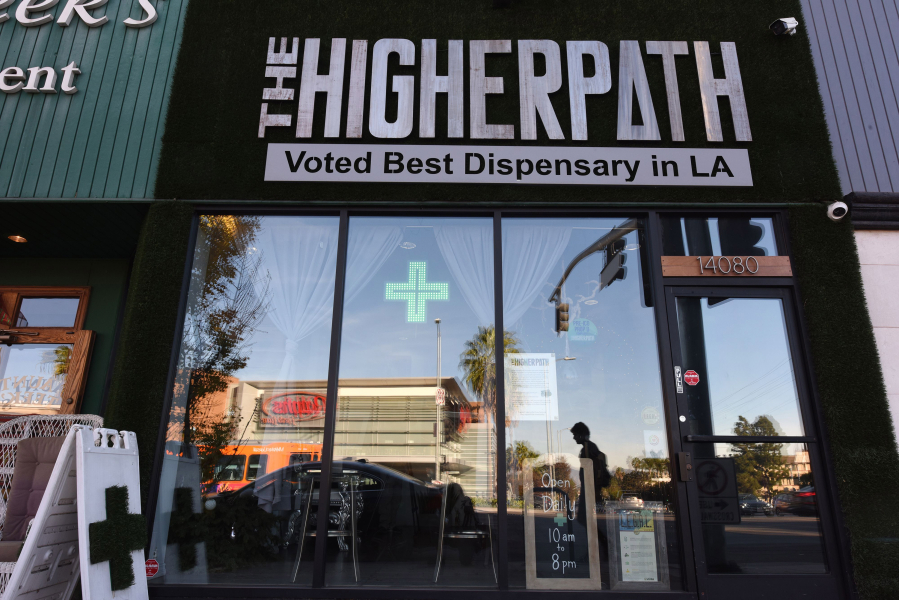 In this photo from December 27, 2017, a man walks by the Higher Path medical marijuana dispensary in the Sherman Oaks area of Los Angeles, California.
