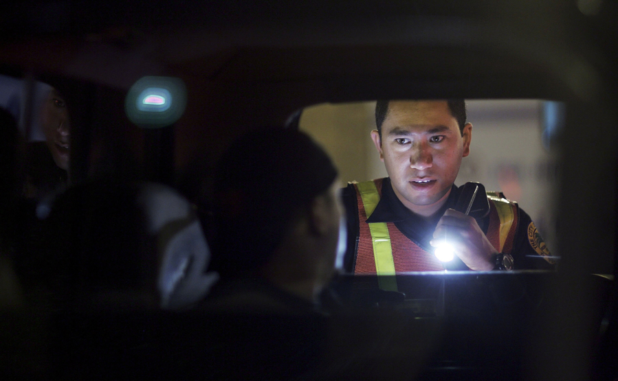 Officer L. Arias from the City of Miami police department questions a driver at a DUI  checkpoint Dec. 15, 2006, in Miami, Florida.
