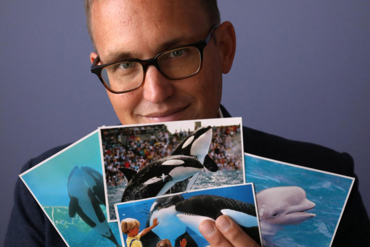 Matthew Strugar, an animal and civil rights attorney who sued SeaWorld several years ago over captive orcas, shows some of the many mysterious postcards he later received.
