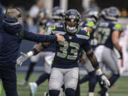 Seattle Seahawks defensive back Jamal Adams celebrates with head coach Pete Carroll during an NFL football game against the San Francisco 49ers, Sunday, Dec. 5, 2021, in Seattle. The Seahawks won 30-23.