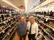 Bob Rosenbloom, 89, left, owner of Bob's Market, and his son Rick, 66 -- holding a $69.99 bottle of Veuve Cliquot champagne that sold for $52 a month ago -- stand in an aisle of the Santa Monica, Calif., store.