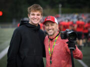 Kris Cavin (right) poses with Camas player Jake Blair on the sidelines at a Camas football game in 2019 (Ken Nowaczyk/For The Columbian)