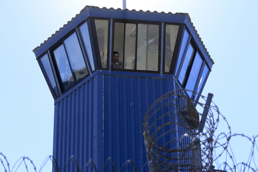 A guard watches from his tower while a group of visiting press enter a secure area on the grounds of Pelican Bay State Prison in Crescent City, California on Oct. 3, 2013.