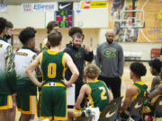Evergreen coach Brett Henry talks to his team during a break in action against Sherwood on Wednesday at the Les Schwab Invitational in Hillsboro. The Plainsmen received an invite to the prestigous tournament on Christmas, one day before it started.