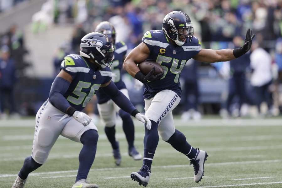 Seattle Seahawks middle linebacker Bobby Wagner (54) runs with the ball after intercepting a pass against the San Francisco 49ers during the first half of an NFL football game, Sunday, Dec. 5, 2021, in Seattle.