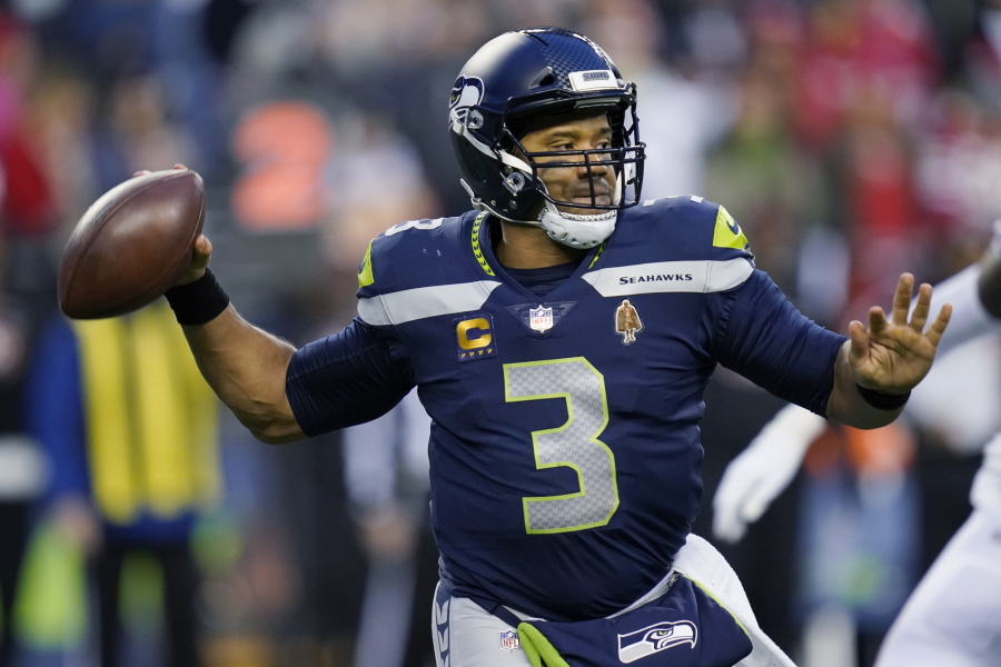 Seattle Seahawks quarterback Russell Wilson looks to pass against the San Francisco 49ers during the second half of an NFL football game, Sunday, Dec. 5, 2021, in Seattle.