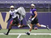Washington wide receiver Puka Nacua, left, runs with wide receiver Sawyer Racanelli, right, during NCAA college football practice, Friday, Oct. 16, 2020, in Seattle. (AP Photo/Ted S.