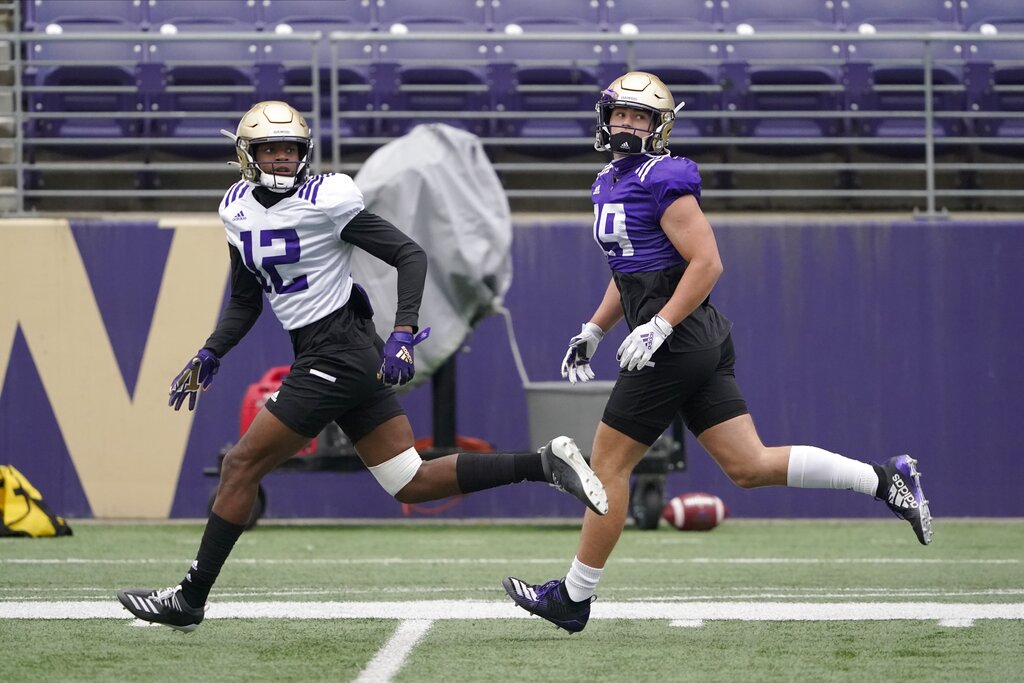 Washington wide receiver Puka Nacua, left, runs with wide receiver Sawyer Racanelli, right, during NCAA college football practice, Friday, Oct. 16, 2020, in Seattle. (AP Photo/Ted S.