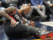 Portland Trail Blazers guard Damian Lillard reacts after being fouled in the first half during an NBA basketball game against the Utah Jazz, Monday, Nov. 29, 2021, in Salt Lake City.