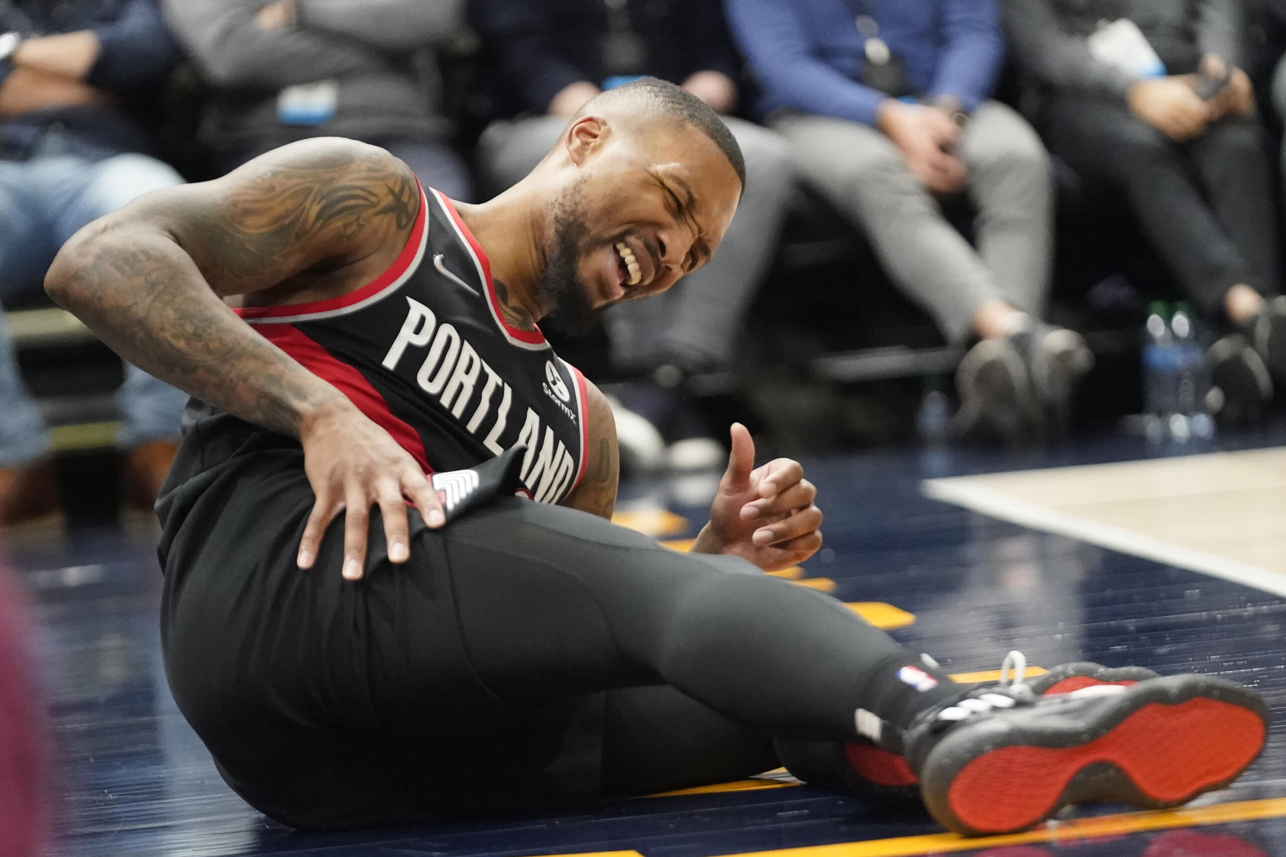 Portland Trail Blazers guard Damian Lillard reacts after being fouled in the first half during an NBA basketball game against the Utah Jazz, Monday, Nov. 29, 2021, in Salt Lake City.