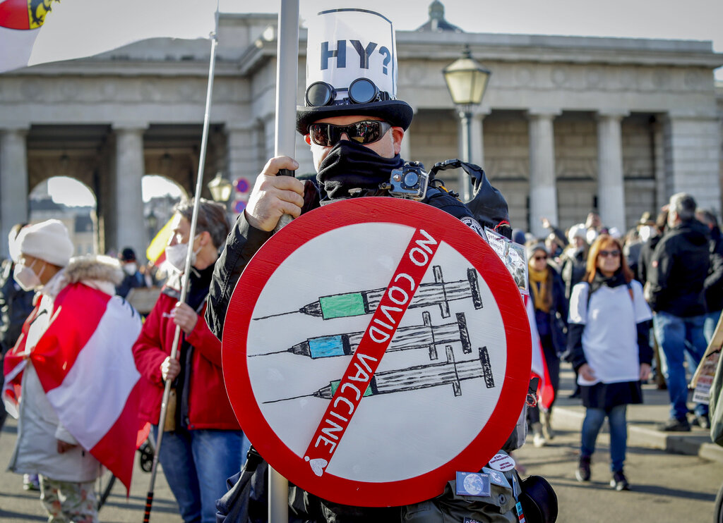 FILE - A man takes part in a demonstration against the country's coronavirus restrictions in Vienna, Austria, Saturday, Nov. 20, 2021. The coronavirus's omicron variant kept a jittery world off-kilter Wednesday Dec.