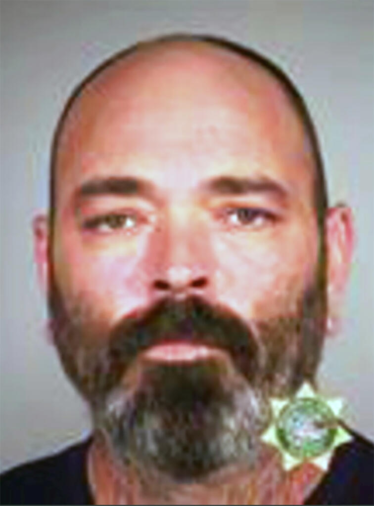 FILE - This undated booking file photo provided by the Multnomah County Sheriff's Office shows Alan James Swinney, a member of the Proud Boys right-wing group. Swinney has been sentenced to 10 years in prison for his violent actions during August 2020 protests in Portland, Oregon.