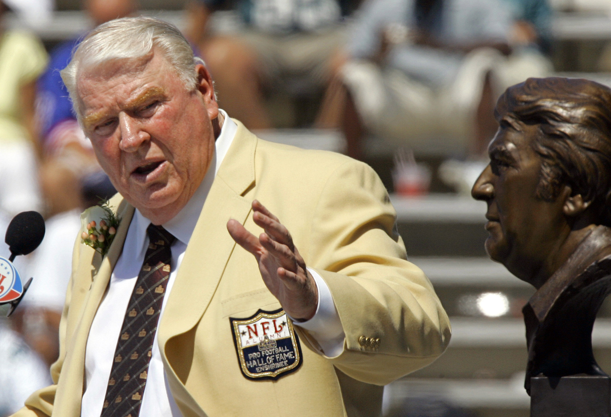 FILE - Former Oakland Raiders coach John Madden gestures toward a bust of himself during his enshrinement into the Pro Football Hall of Fame in Canton, Ohio, Aug. 5, 2006. John Madden, the Hall of Fame coach turned broadcaster whose exuberant calls combined with simple explanations provided a weekly soundtrack to NFL games for three decades, died Tuesday, Dec. 28, 2021, the NFL said. He was 85.