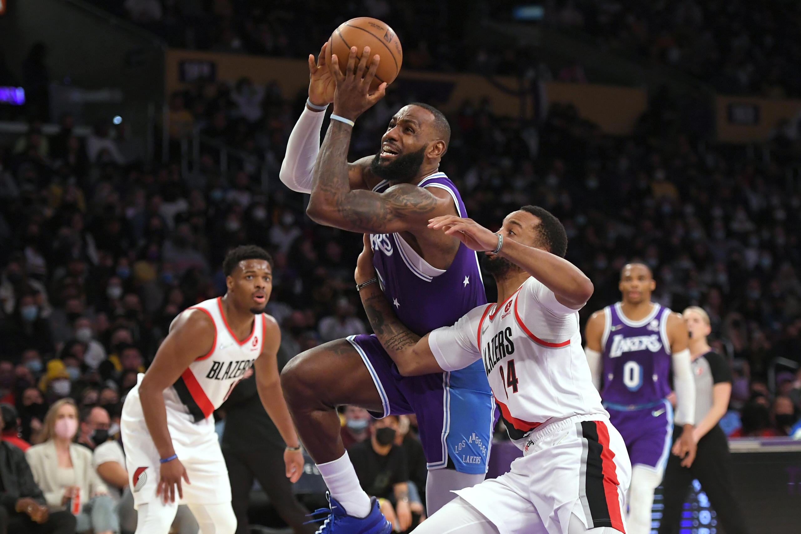 Los Angeles Lakers forward LeBron James (6) gets past Portland Trail Blazers forward Norman Powell (24) during the first half of an NBA basketball game Friday Dec. 31, 2021, in Los Angeles.