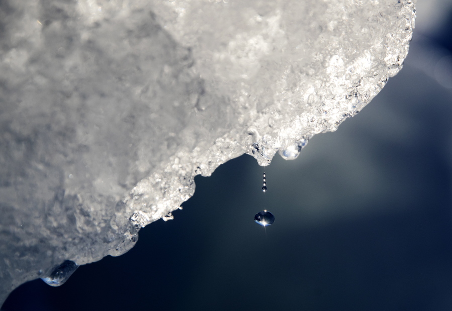 FILE - A drop of water falls off an iceberg melting in the Nuup Kangerlua Fjord near Nuuk in southwestern Greenland, Tuesday, Aug. 1, 2017. According to a report by the U.S. National Oceanic and Atmospheric Administration released on Tuesday, Dec. 14, 2021, the Arctic continues to deteriorate from global warming, not setting as many records this year as in the past, but still changing so rapidly that federal scientists call it alarming.