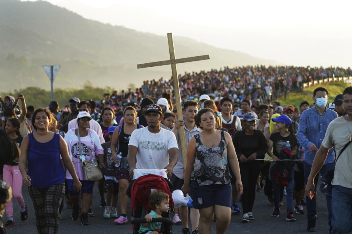 FILE - Migrants leave Huixtla, Chiapas state, Mexico, Oct. 27, 2021, as they continue their trek north toward Mexico's northern states and the U.S. border. The Biden administration struck agreement with Mexico to reinstate a Trump-era border policy next week that forces asylum-seekers to wait in Mexico for hearings in U.S. immigration court, U.S. officials said Thursday.