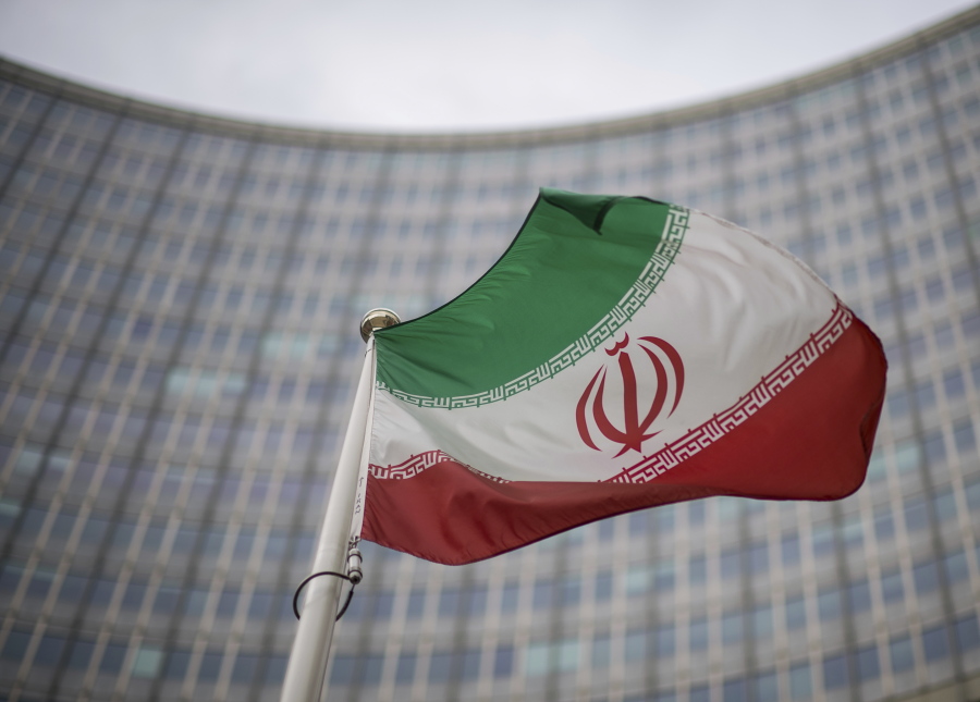 A national flag of Iran waves in front of the building of the International Atomic Energy Agency, IAEA, in Vienna, Austria, Friday, Dec. 17, 2021.