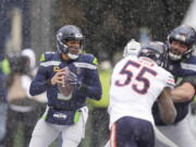 Seattle Seahawks quarterback Russell Wilson, left, looks to pass against the Chicago Bears  on Sunday in Seattle. Wilson hasn't led a late game-winning drive this season.