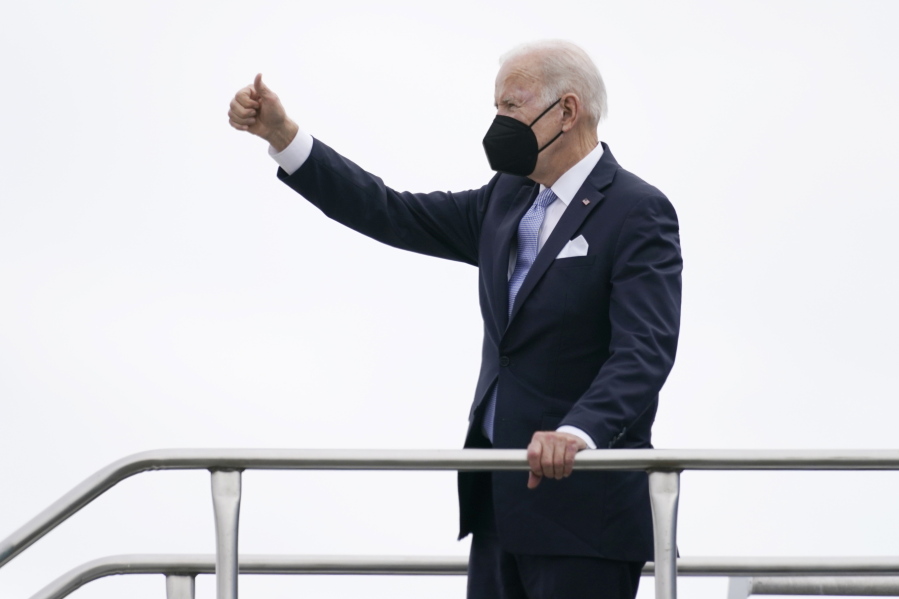 President Joe Biden gives a thumbs up as he boards Air Force One at Columbia Metropolitan Airport in West Columbia, S.C., en route to Philadelphia after speaking at the South Carolina State University's 2021 Fall Commencement Ceremony in Orangeburg, S.C., Friday, Dec. 17, 2021.