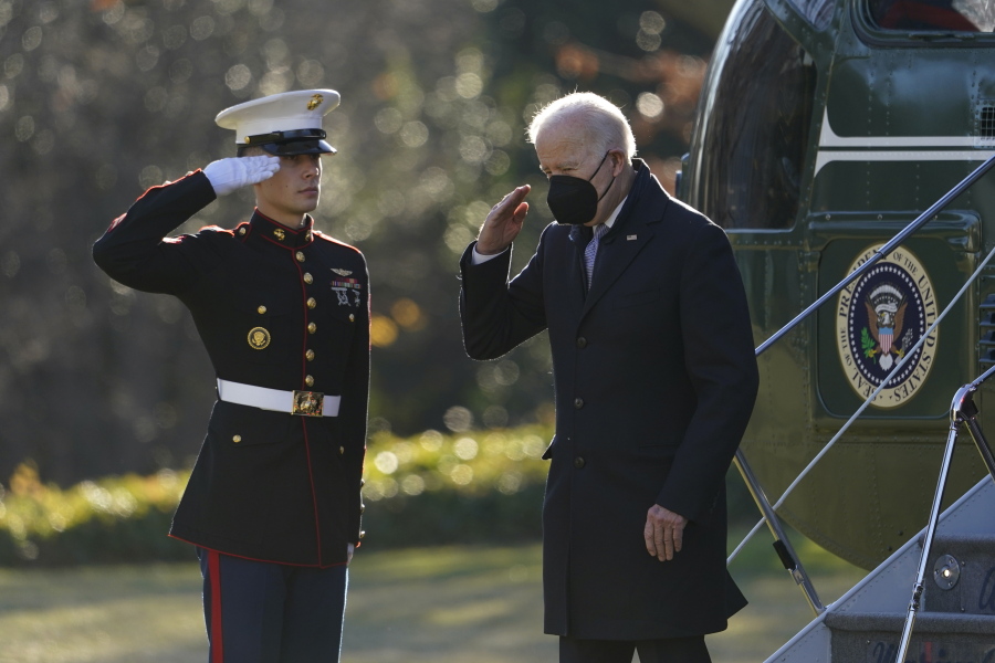 President Joe Biden salutes as he steps off Marine One on the South Lawn of the White House in Washington, Monday, Dec. 20, 2021. Biden is returning to Washington after spending the weekend at his home in Delaware.