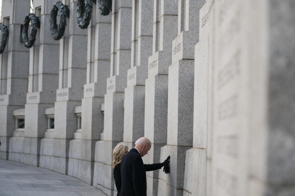 President Joe Biden and first lady Jill Biden visit the National World War II Memorial to mark the 80th anniversary of the Japanese attack on Pearl Harbor, Tuesday, Dec. 7, 2021, in Washington.